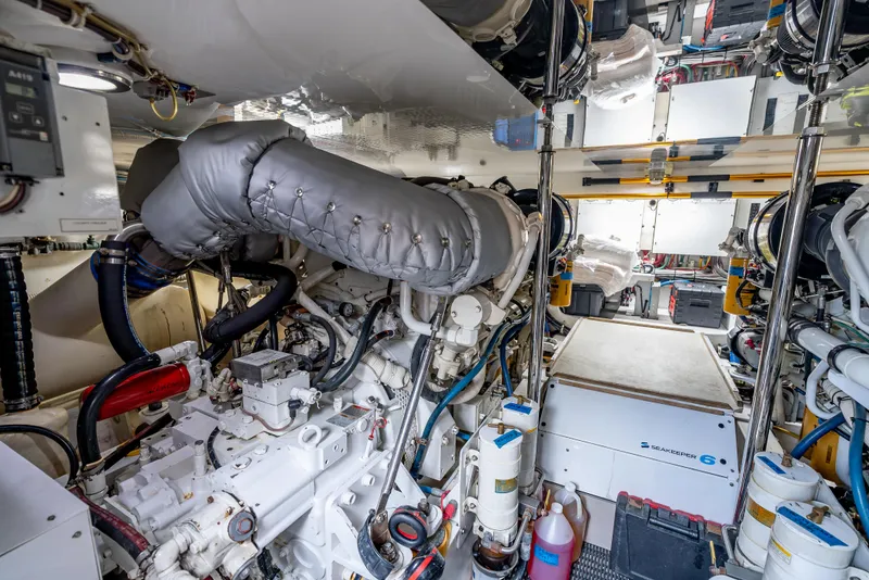 Slide: The Image of Engine room of 2010 Hatteras 60 Convertible yacht, showcasing machinery and equipment. - 48