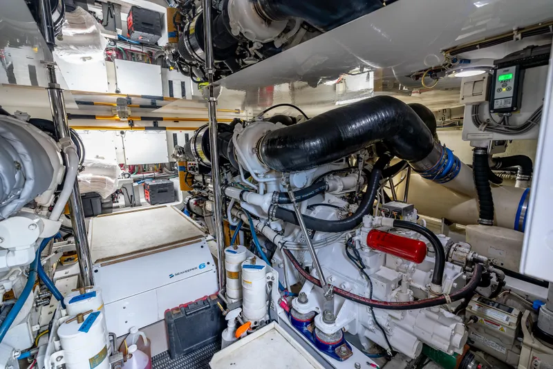 Slide: The Image of Engine room of 2010 Hatteras 60 Convertible yacht, showcasing complex machinery and equipment. - 49