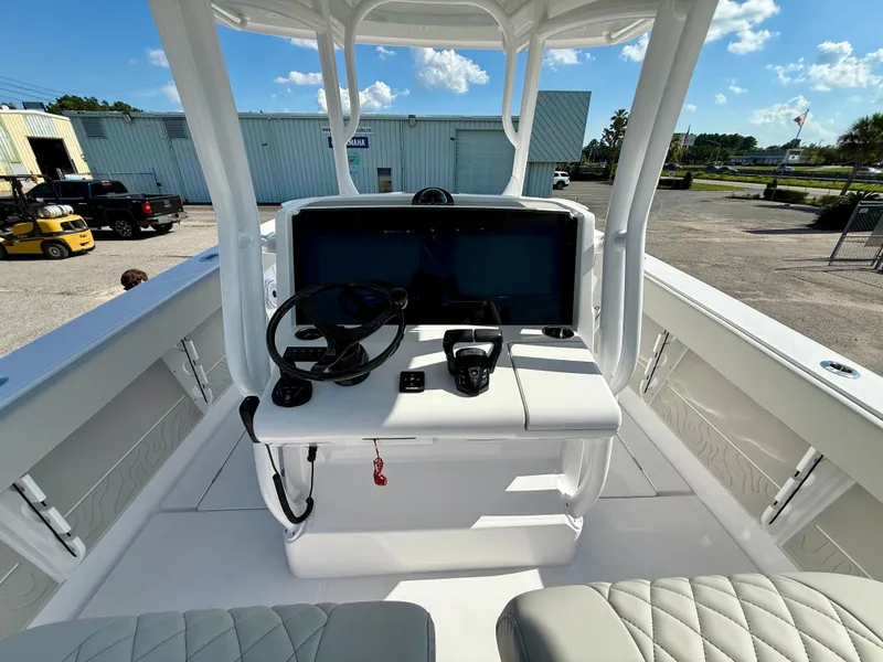 Slide: The Image of Center console of a 2026 Jupiter 34 boat with steering wheel and controls. - 11