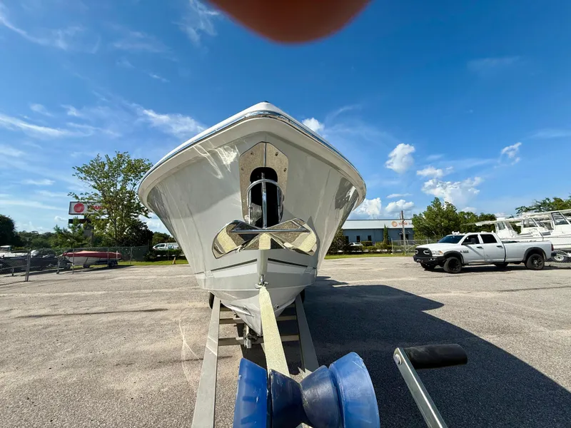 Slide: The Image of 2026 Jupiter 34 boat on trailer in sunny outdoor setting. - 5