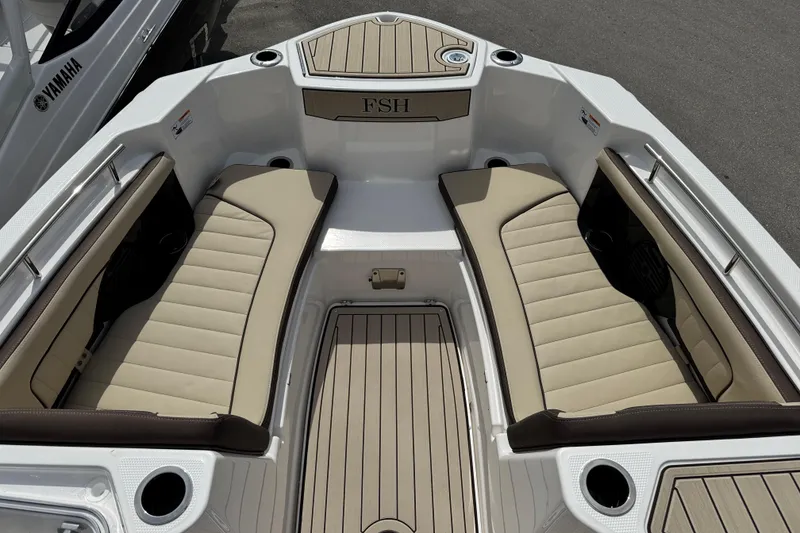 Slide: The Image of 2025 Yamaha Boats 252 FSH Sport interior with beige seating and sleek design. - 11