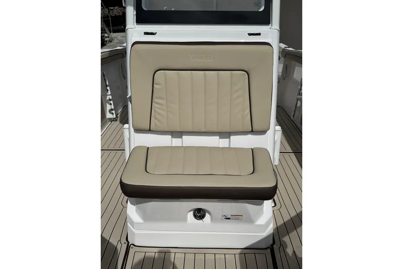 Slide: The Image of 2025 Yamaha Boats 252 FSH Sport seat with beige upholstery and sleek design. - 17