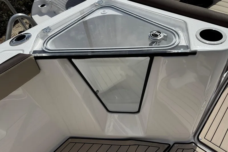 Slide: The Image of 2025 Yamaha Boats 252 FSH Sport deck with storage compartment and cup holders. - 21