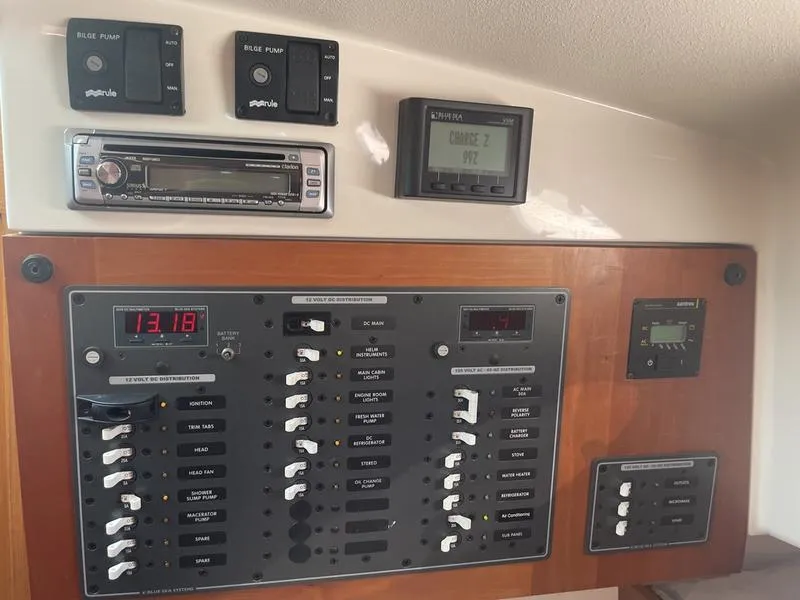 Slide: The Image of Electrical control panel on a 2006 Back Cove 29 boat, featuring switches and displays. - 18