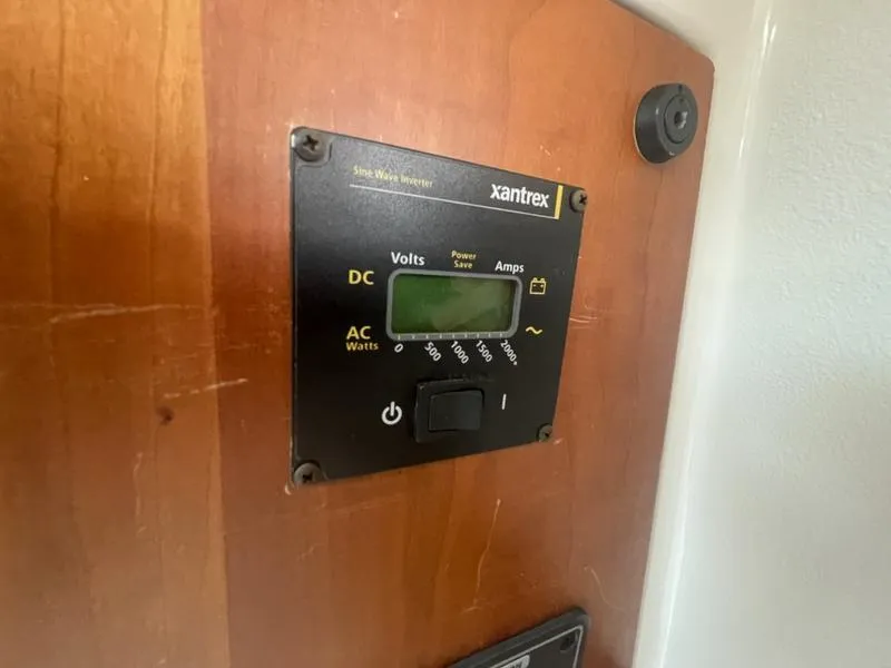 Slide: The Image of Xantrex inverter panel on 2006 Back Cove 29 boat, displaying volts and amps. - 20