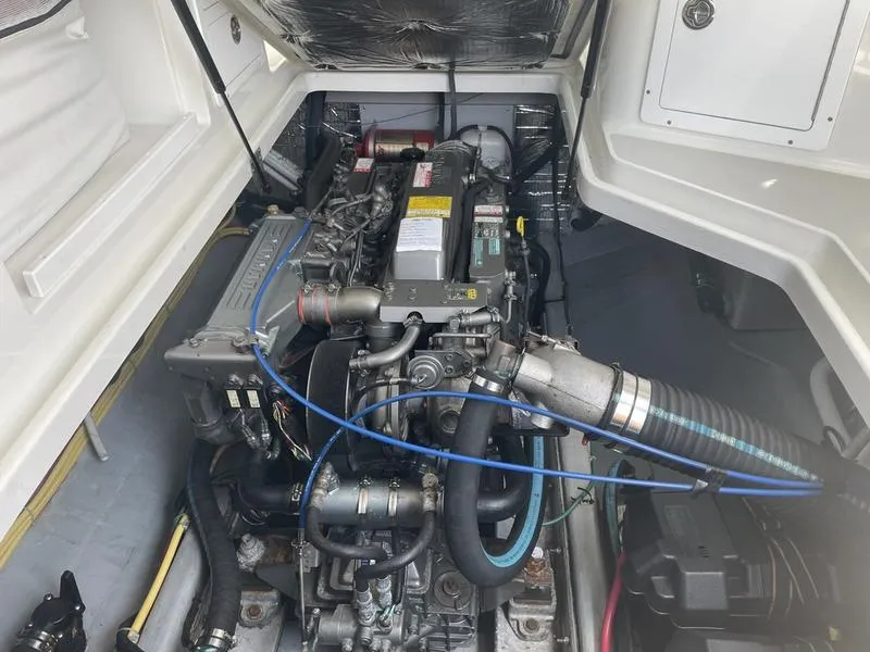 Slide: The Image of Engine compartment of a 2006 Back Cove 29 boat, showcasing detailed mechanical components. - 27