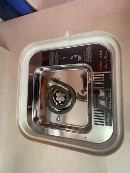 Slide: The Image of Electric stove on a 2006 Back Cove 29 boat, featuring a single coil burner. - 28