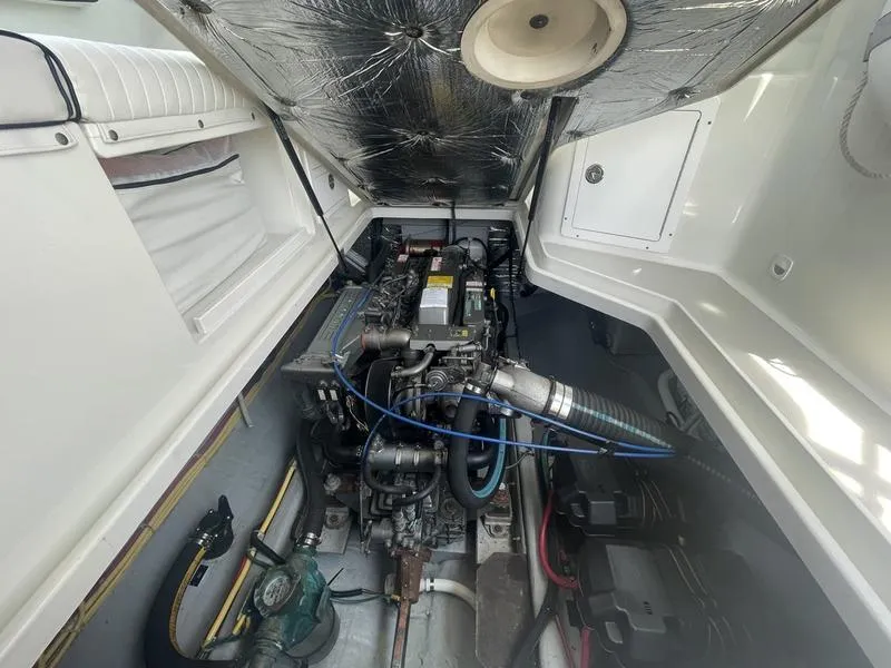 Slide: The Image of Engine compartment of a 2006 Back Cove 29 boat, showcasing mechanical components. - 29