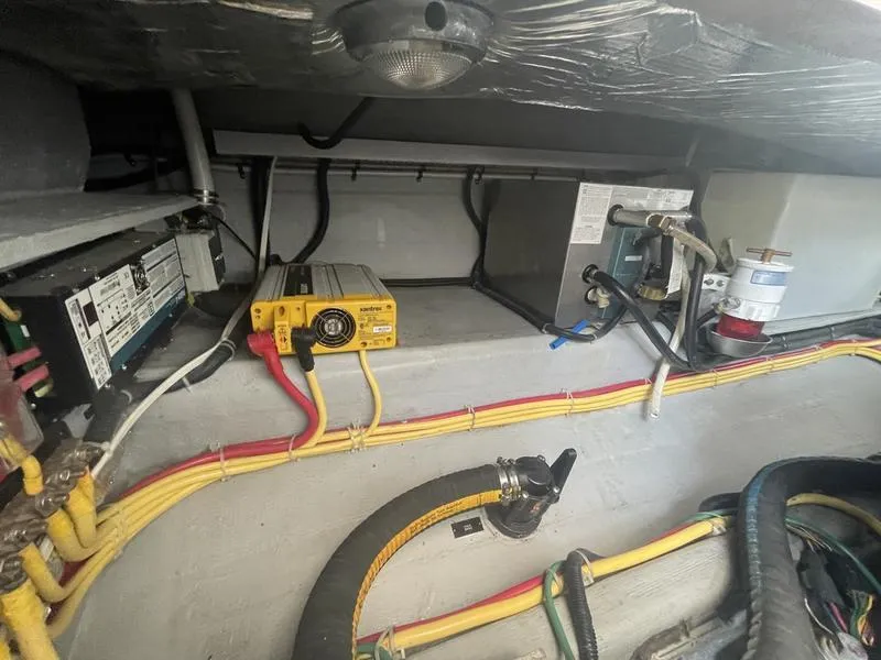 Slide: The Image of Engine compartment of a 2006 Back Cove 29 boat, featuring wiring and equipment. - 30