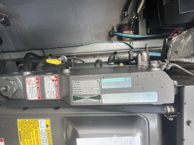 Slide: The Image of Engine compartment of a 2006 Back Cove 29 boat, featuring labels and components. - 33