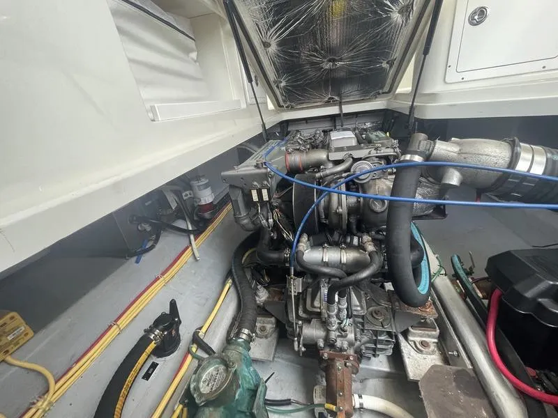 Slide: The Image of Engine compartment of a 2006 Back Cove 29 boat, showcasing detailed mechanical components. - 34