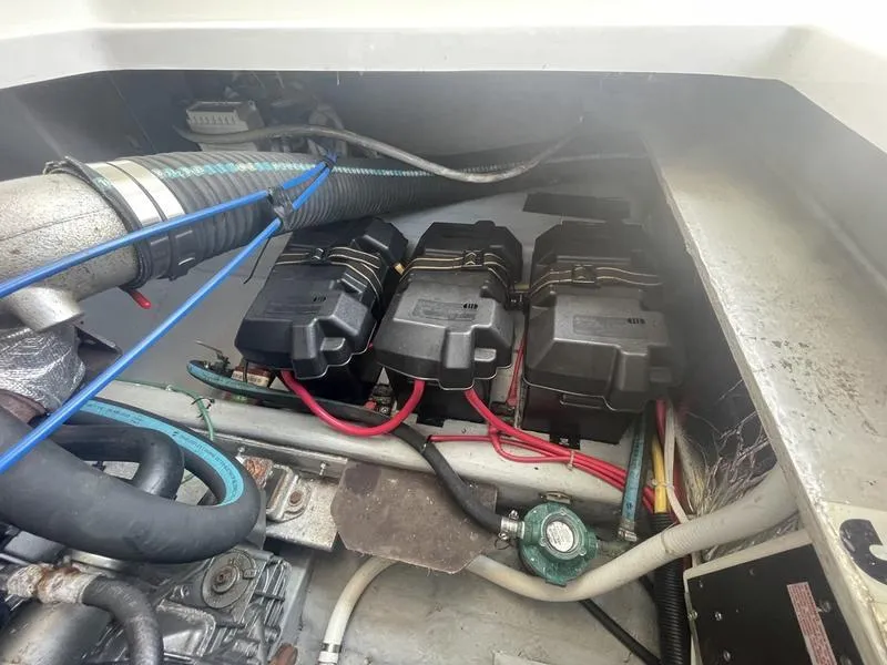 Slide: The Image of Engine compartment of a 2006 Back Cove 29 boat, showing battery setup and wiring. - 35