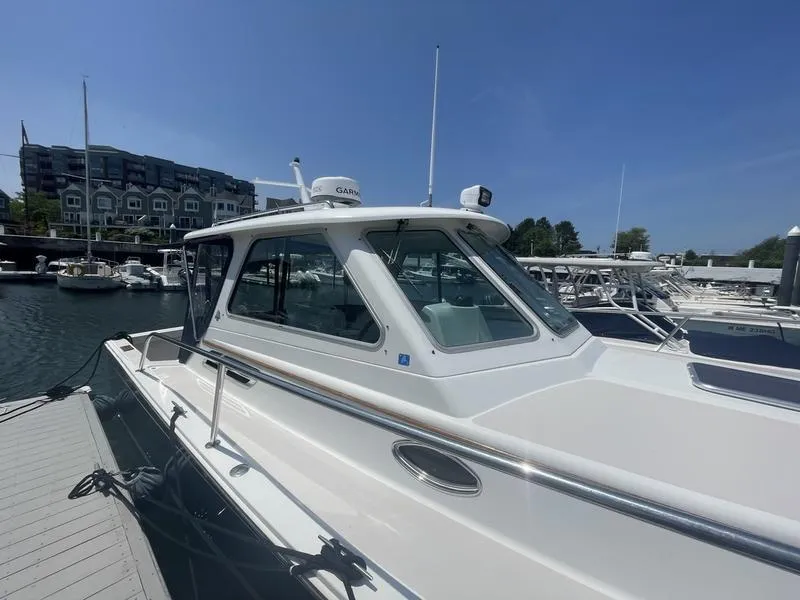 Slide: The Image of 2006 Back Cove 29 boat docked at marina under clear blue sky. - 4