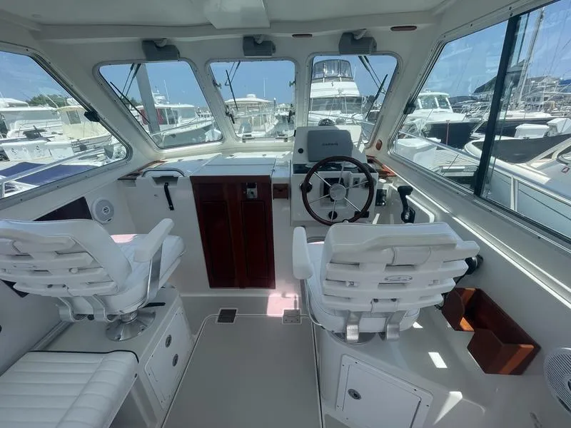 Slide: The Image of Interior of a 2006 Back Cove 29 boat with helm and seating. - 5