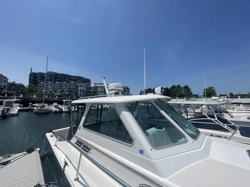Slide: The Image of 2006 Back Cove 29 boat docked at marina under clear blue sky. - 7
