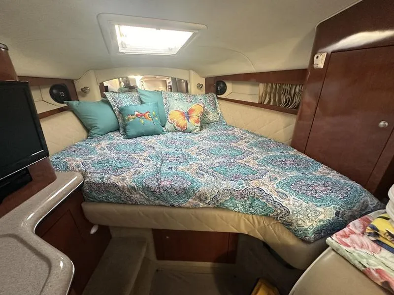 Slide: The Image of Cozy cabin interior of 2007 Sea Ray 300 Sundancer with colorful bedding and pillows. - 10