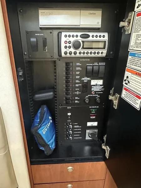 Slide: The Image of Electrical control panel inside 2007 Sea Ray 300 Sundancer boat, featuring various switches and controls. - 14