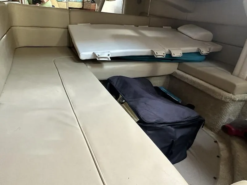Slide: The Image of Interior cabin of 2007 Sea Ray 300 Sundancer with beige seating and storage. - 15