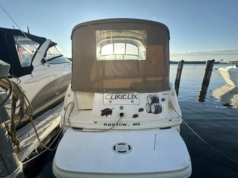 Slide: The Image of 2007 Sea Ray 300 Sundancer docked at marina, rear view with canvas cover. - 3