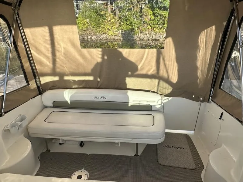 Slide: The Image of 2007 Sea Ray 300 Sundancer interior with cushioned seating and beige canopy. - 9