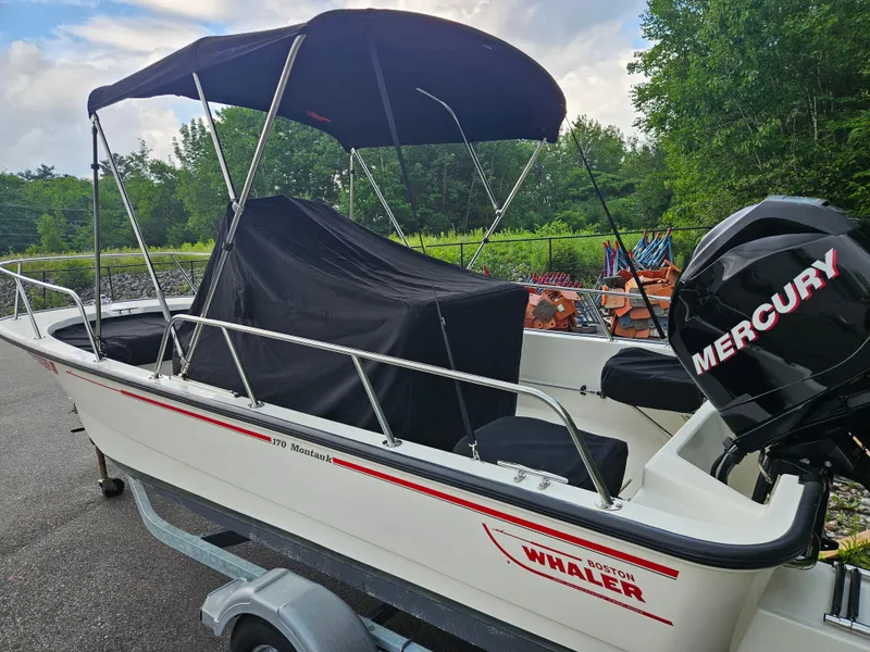 Slide: The Image of 2008 Boston Whaler 170 Montauk boat with Mercury engine, parked on a trailer. - 12