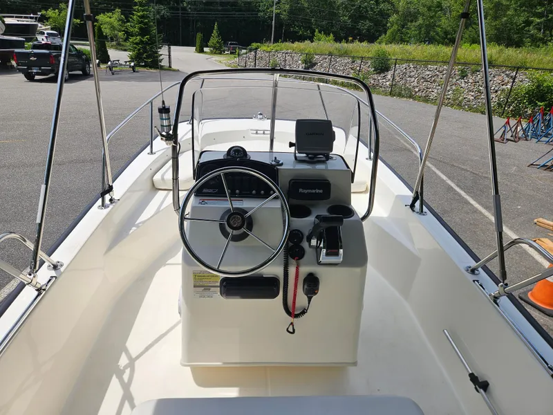 Slide: The Image of 2008 Boston Whaler 170 Montauk boat interior with steering wheel and navigation equipment. - 22