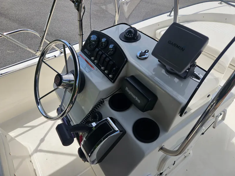 Slide: The Image of 2008 Boston Whaler 170 Montauk boat console with steering wheel, Garmin and Raymarine devices. - 24