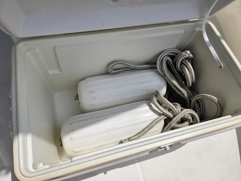 Slide: The Image of Open storage compartment with ropes and fenders on a 2008 Boston Whaler 170 Montauk boat. - 30