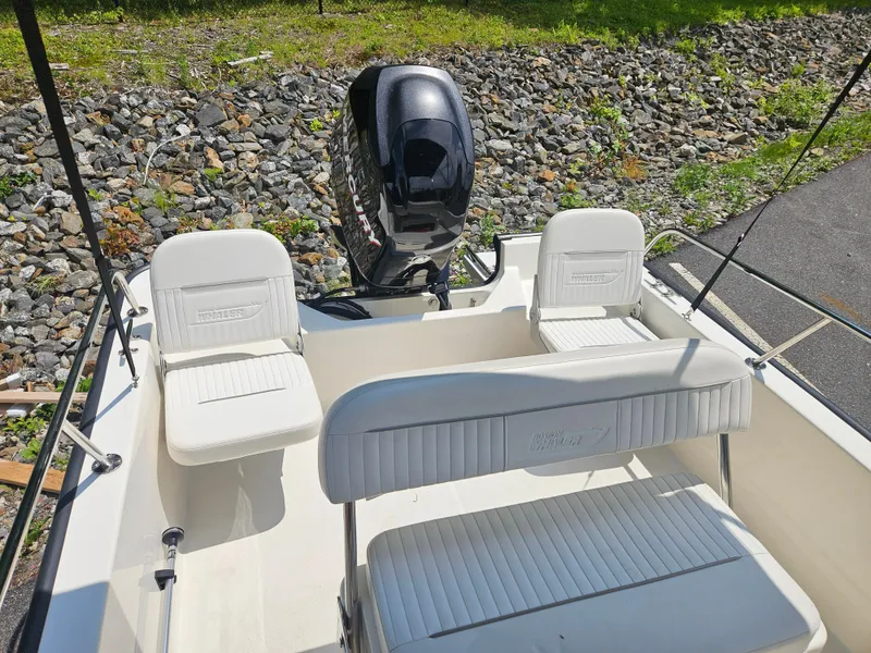 Slide: The Image of 2008 Boston Whaler 170 Montauk boat interior with seating and outboard motor. - 32