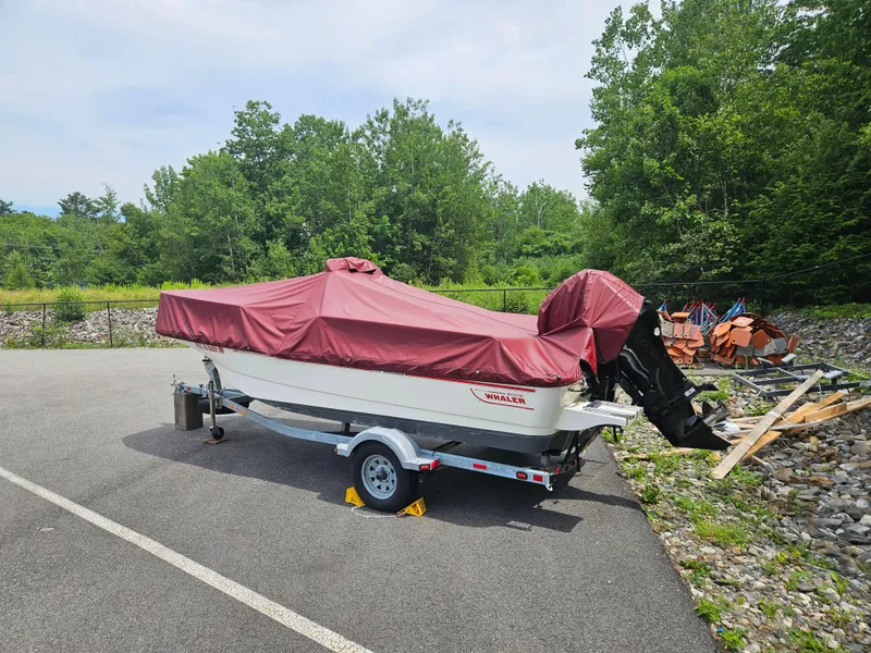 Slide: The Image of 2008 Boston Whaler 170 Montauk boat covered, parked on trailer in outdoor setting. - 35