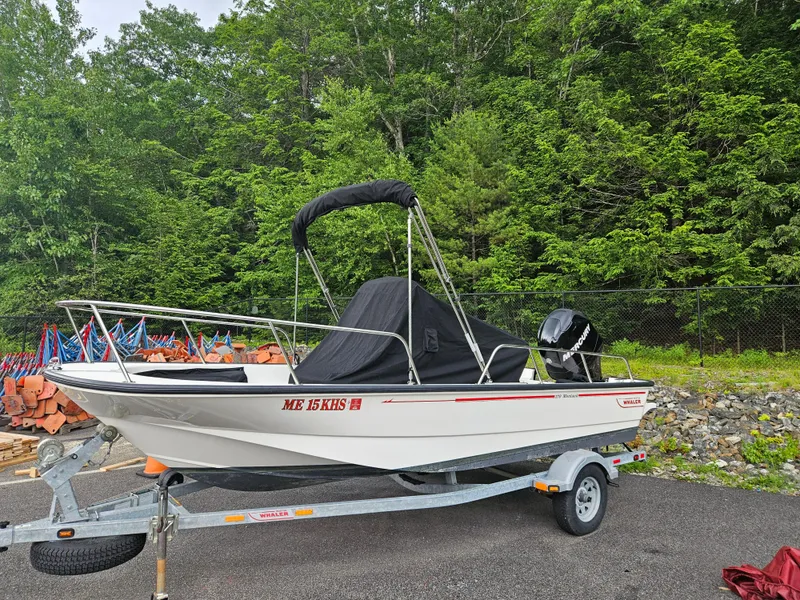 Slide: The Image of 2008 Boston Whaler 170 Montauk boat on trailer, surrounded by lush greenery. - 4