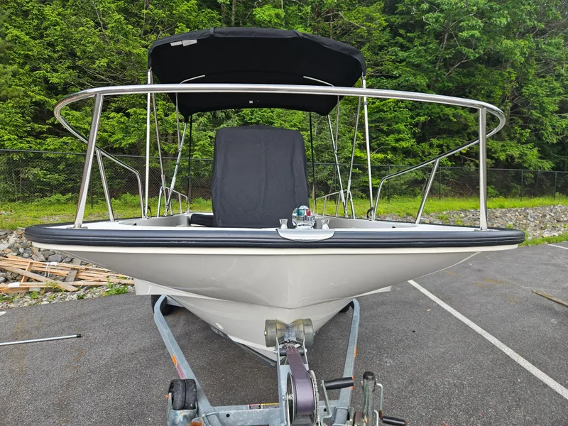Slide: The Image of 2008 Boston Whaler 170 Montauk boat on trailer, surrounded by greenery. - 6