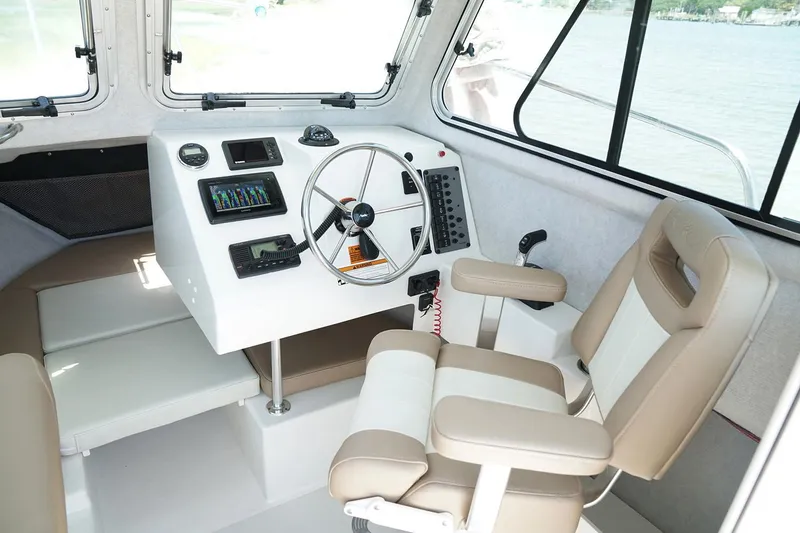 Slide: The Image of Manufacturer Provided Image: Interior of a 2020 Parker 2120 Sport Cabin boat with steering wheel and captain's chair. - 3