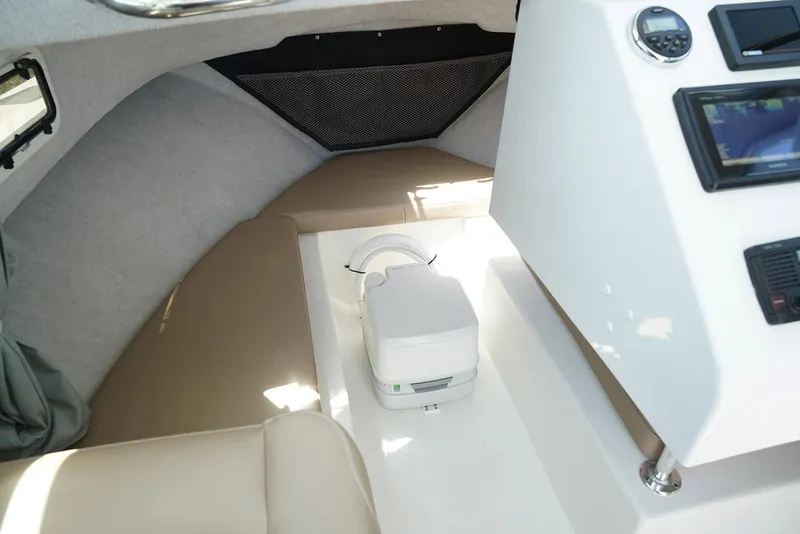 Slide: The Image of Manufacturer Provided Image: Interior cabin of a 2020 Parker 2120 Sport Cabin boat with seating and a portable toilet. - 5