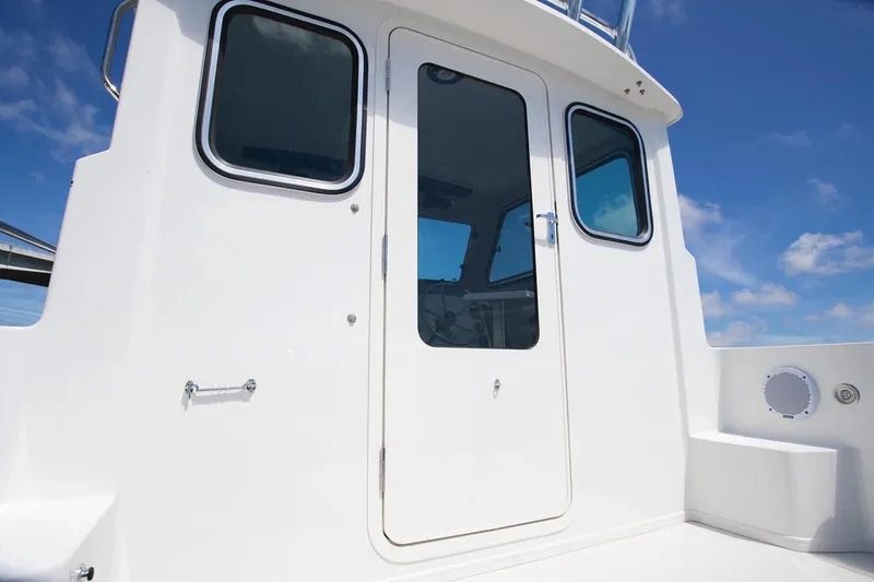 Slide: The Image of Manufacturer Provided Image: Parker 2120 Sport Cabin 2020 boat exterior with door and windows. - 6