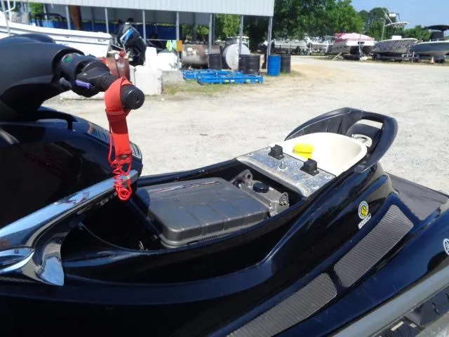Slide: The Image of 2007 Yamaha WaveRunner FX HO with open storage compartment in a boatyard setting. - 2