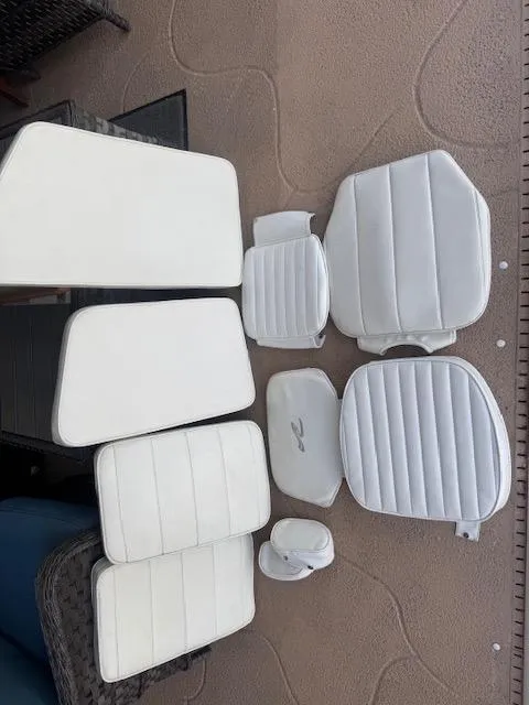 Slide: The Image of White boat cushions for 1997 Sea Ray Laguna 21, arranged on a textured surface. - 4