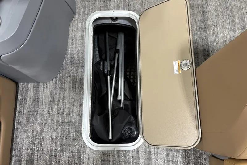 Slide: The Image of Storage compartment on 2025 Godfrey Sweetwater 2286 SFL iMPACT pontoon boat, open with equipment inside. - 14