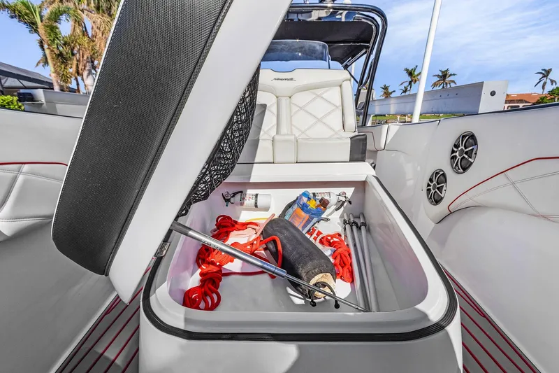 Slide: The Image of Open storage compartment in 2020 Renegade 33' Open boat with marine accessories. - 13