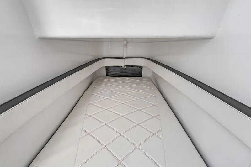 Slide: The Image of Interior cabin of 2020 Renegade 33' Open boat with white cushioned seating. - 14