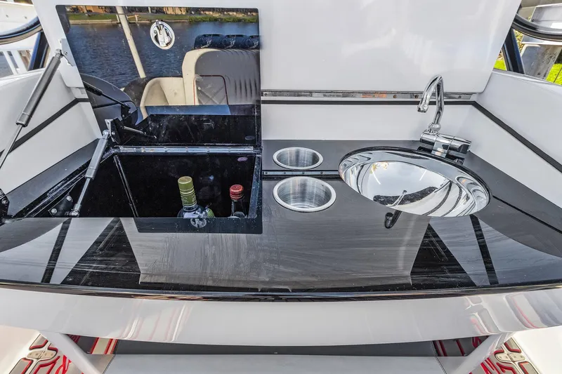 Slide: The Image of Renegade 33' Open 2020 boat interior with sink, countertop, and beverage storage. - 19