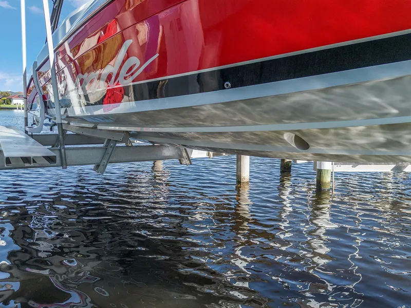 Slide: The Image of Red 2020 Renegade 33' Open boat on lift above water. - 24