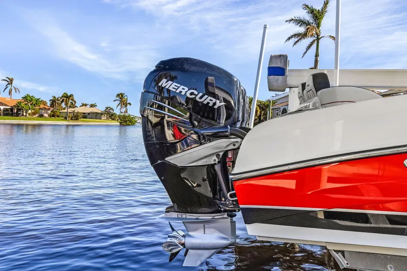 Slide: The Image of 2020 Renegade 33' Open boat with Mercury outboard engine on a sunny waterfront. - 3