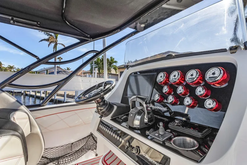 Slide: The Image of Cockpit of 2020 Renegade 33' Open boat with gauges and steering wheel. - 9