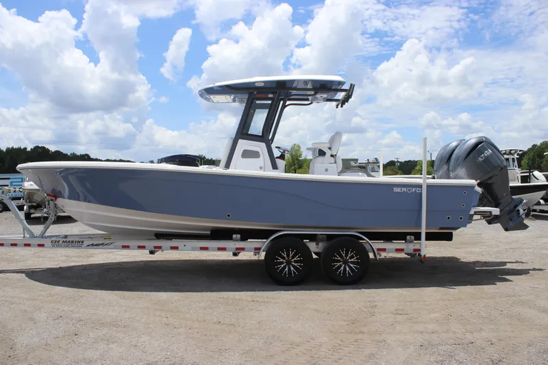 The Image of 2025 Sea Fox 282 Hybrid LT boat on trailer under blue sky. - 0