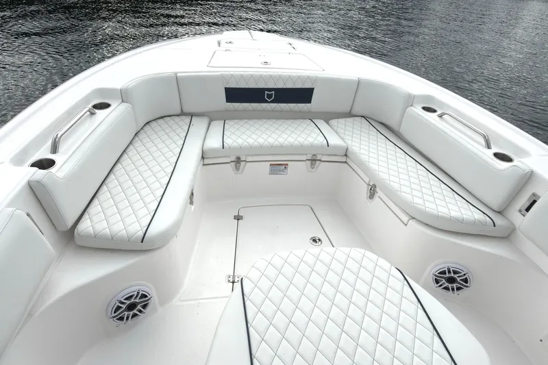 Slide: The Image of 2025 Sea Fox 282 Hybrid LT boat interior with white quilted seating and cup holders. - 10