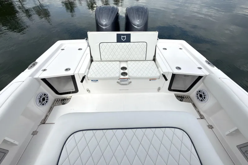 Slide: The Image of 2025 Sea Fox 282 Hybrid LT boat interior with cushioned seating and dual engines. - 15