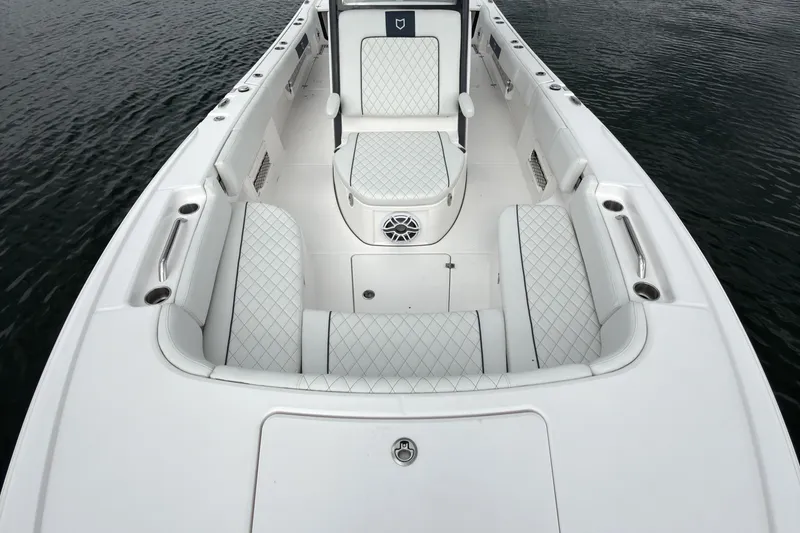 Slide: The Image of 2025 Sea Fox 282 Hybrid LT boat interior with white quilted seating and sleek design. - 20