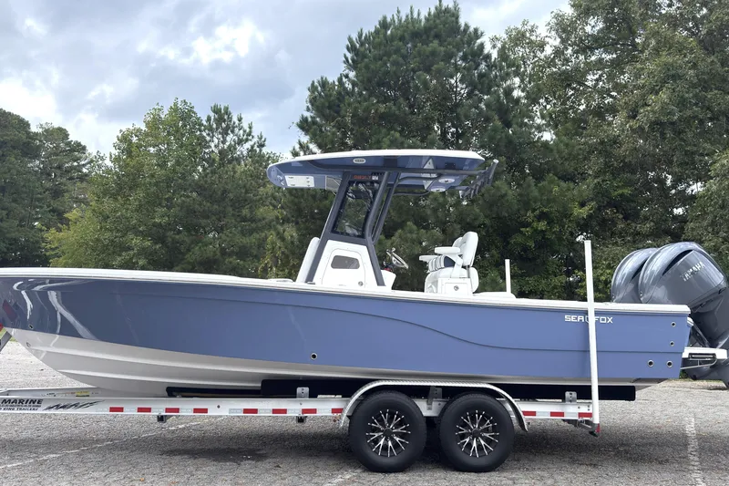 Slide: The Image of 2025 Sea Fox 282 Hybrid LT boat on trailer, parked outdoors. - 4