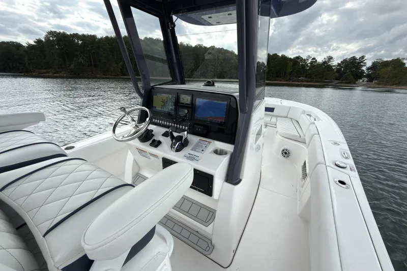Slide: The Image of 2025 Sea Fox 282 Hybrid LT boat interior with advanced navigation system on calm water. - 7